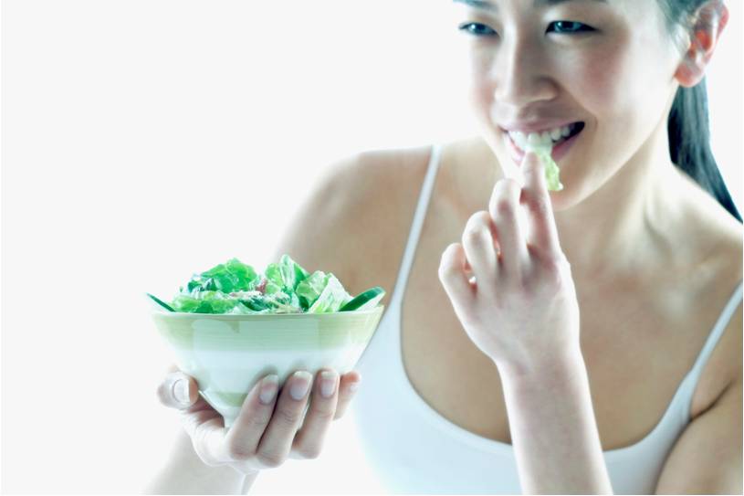 lady eating a salad to help with spine pain